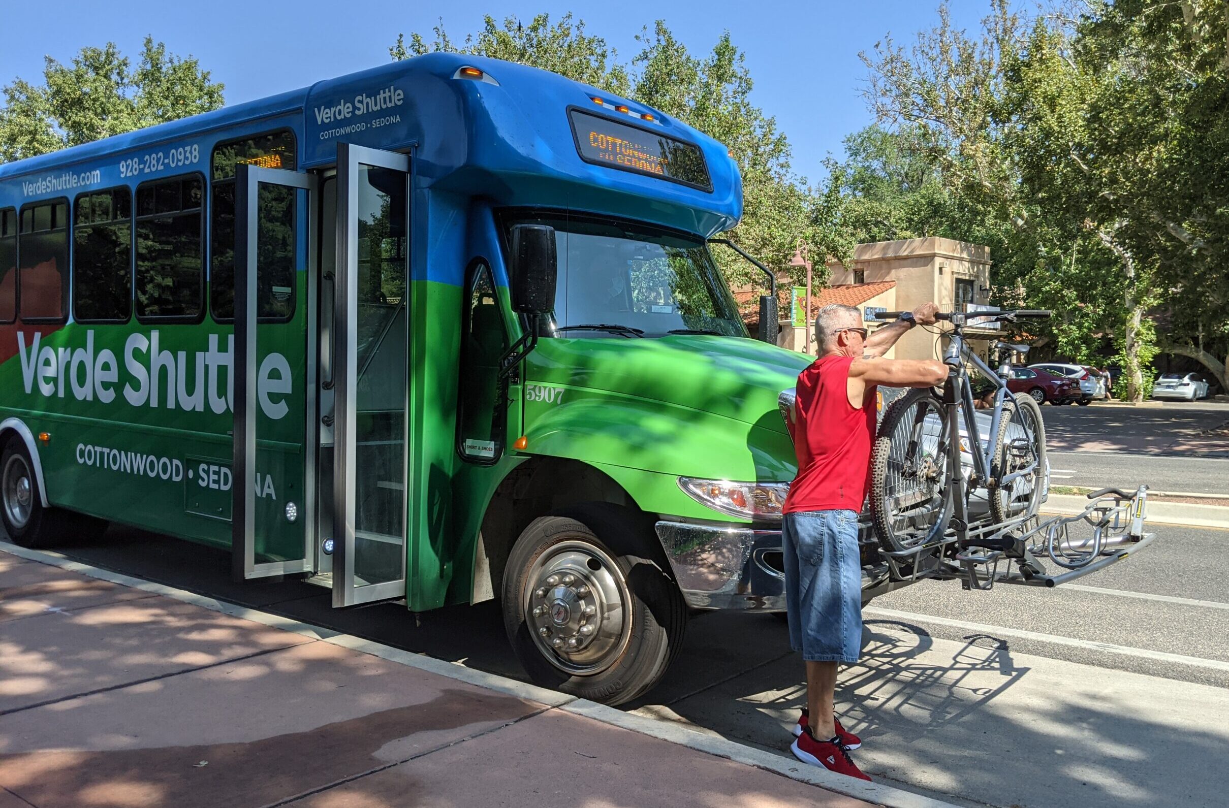 Man loading bike on bus